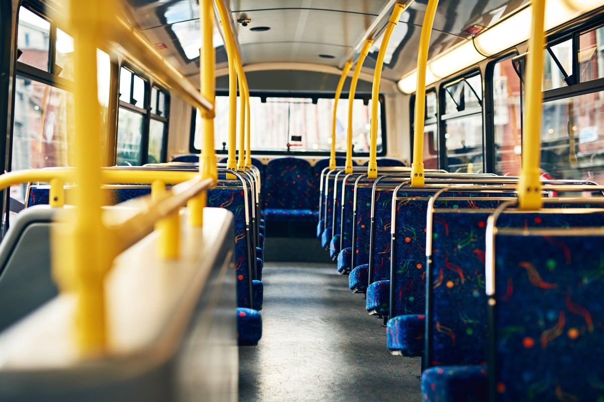 Cropped view of the comfortable, generously spaced seats inside a premium bus