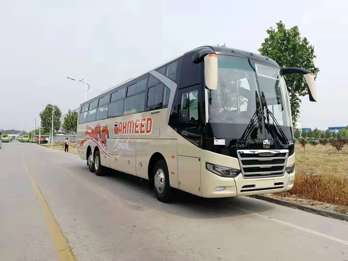Tahmeed Express coach bus parked on a highway with rural landscape